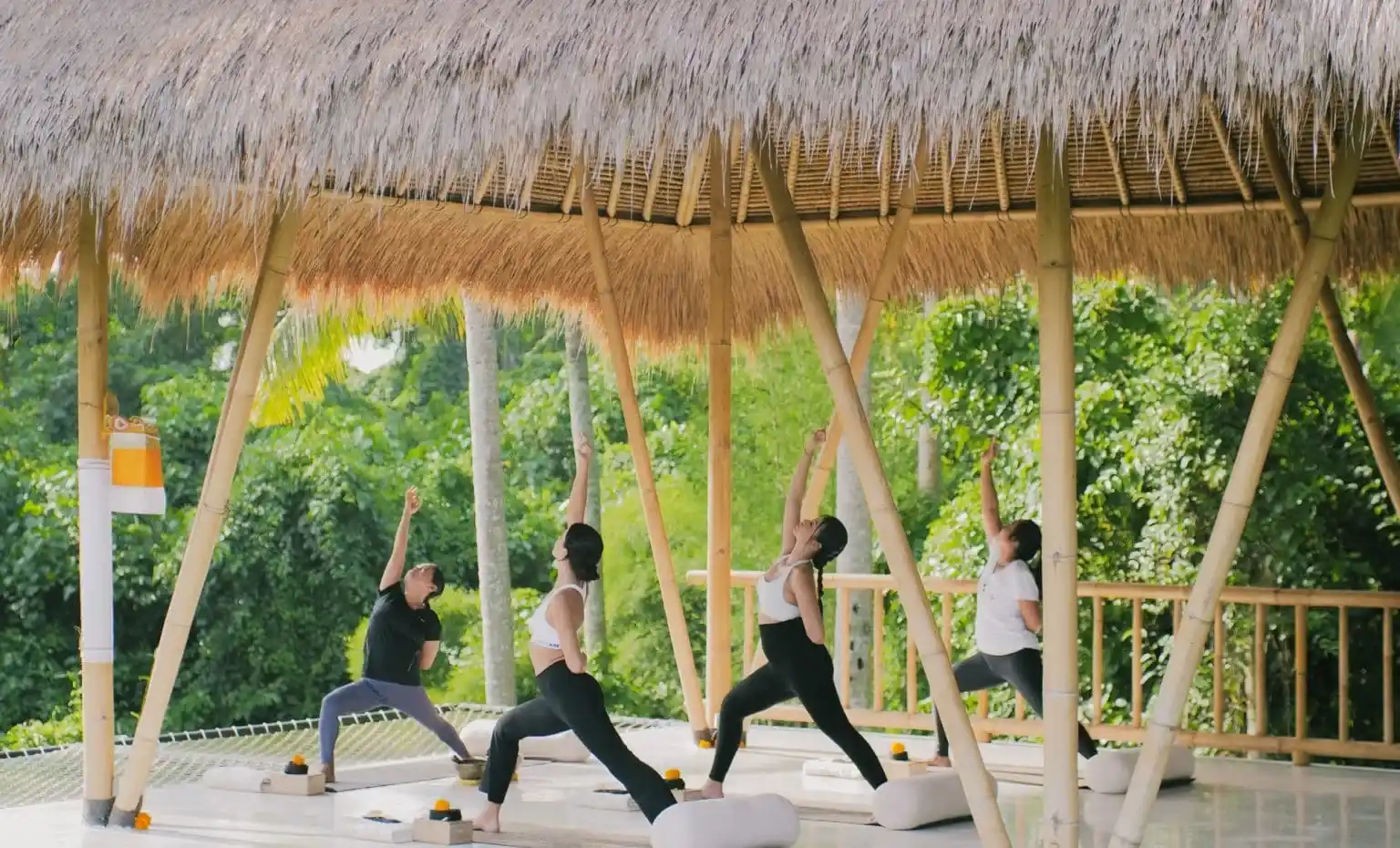 A morning yoga class in a bamboo pavilion