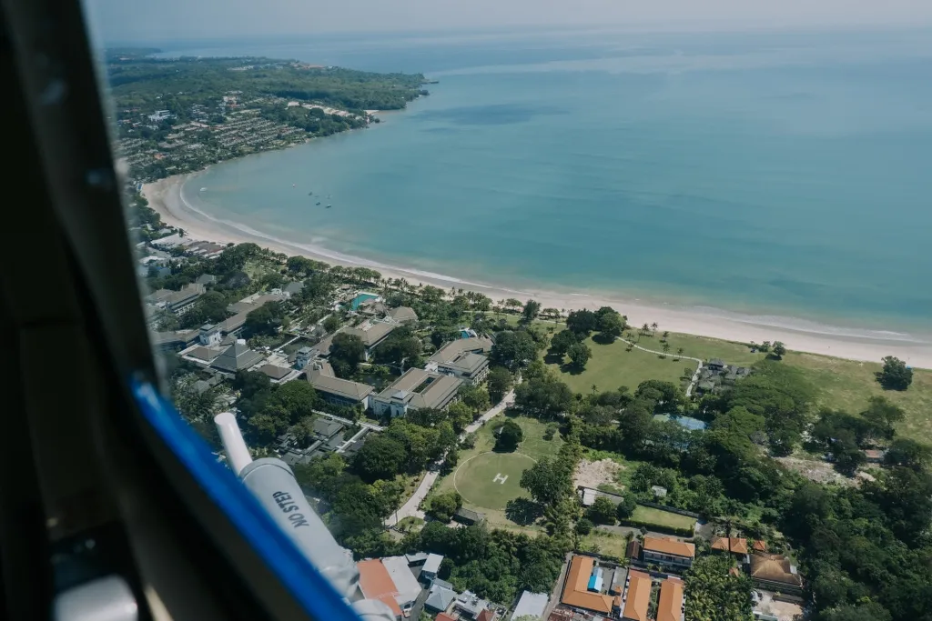 Aerial view of a Balinese sea temple on a rocky headland