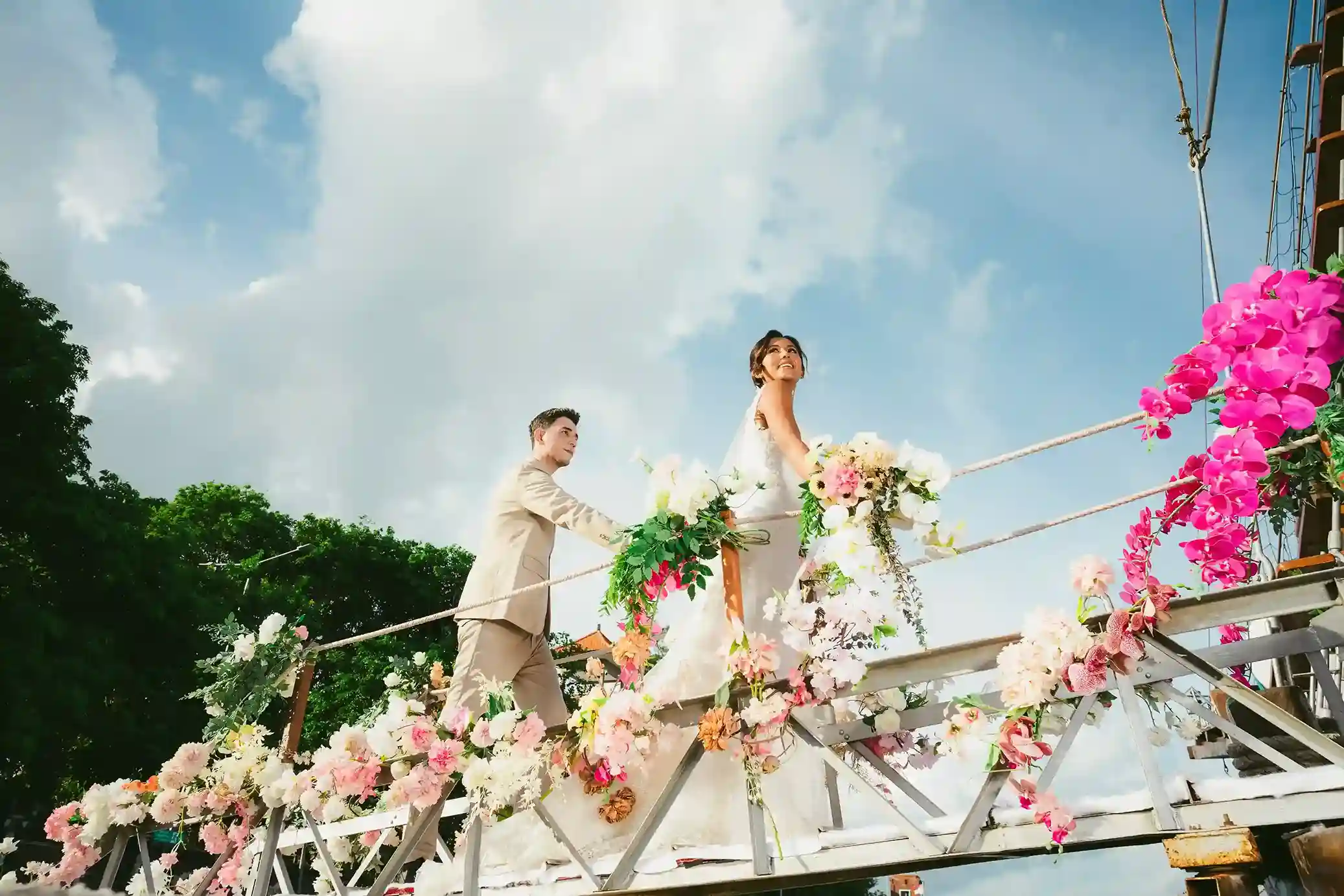 Beach wedding aisle and floral arch facing the sea