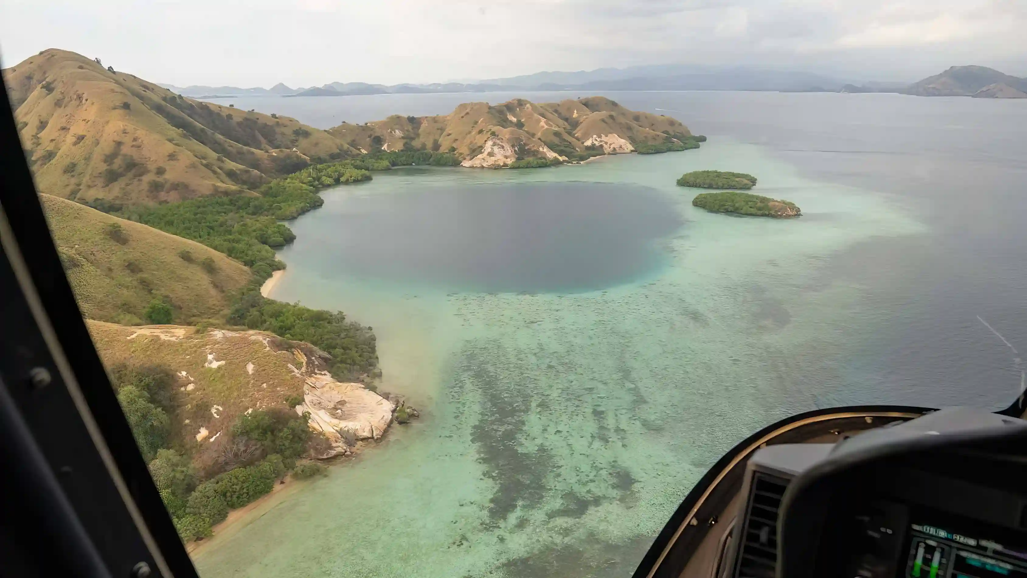 Charter vessels at anchor seen from the air over Komodo